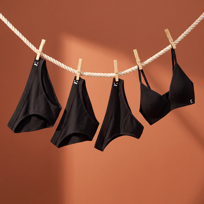 Black Rudie underwear and a bralette hanging on a clothesline in supplied campaign artwork.