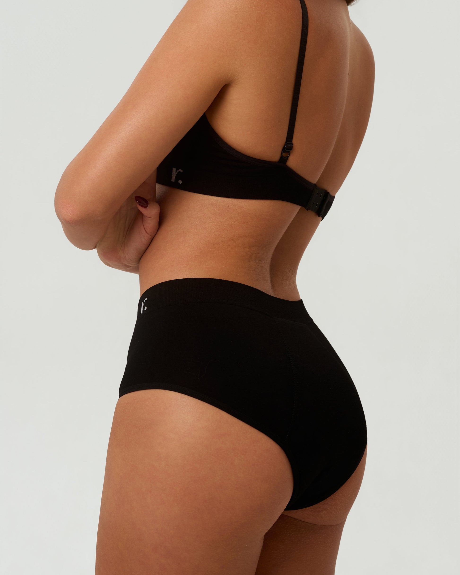 Rudie Leakproof High-Waist Brief in black — half-body rear side angle, seamless period brief